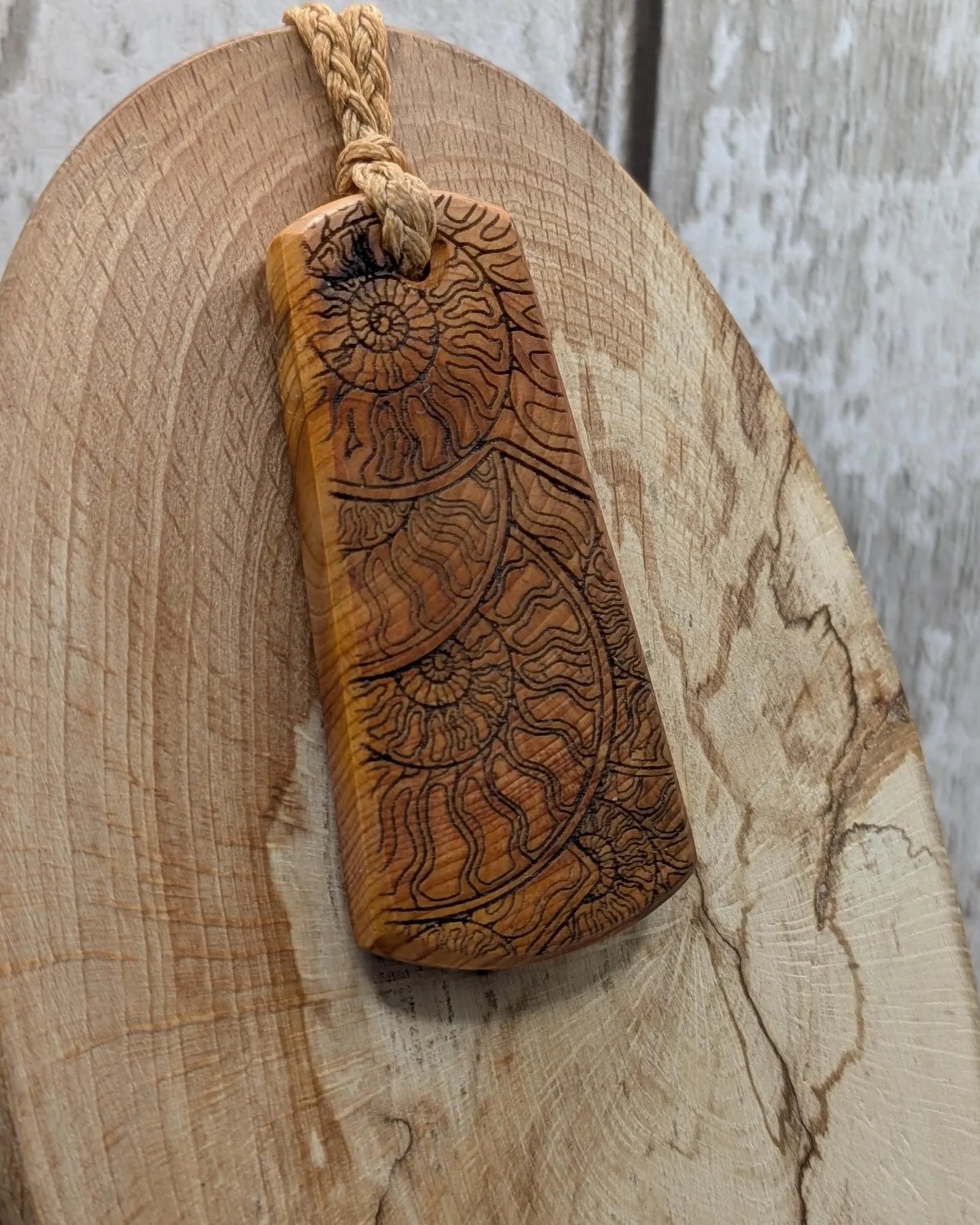 Laser printed all over ammonite on yew wood Pendant.