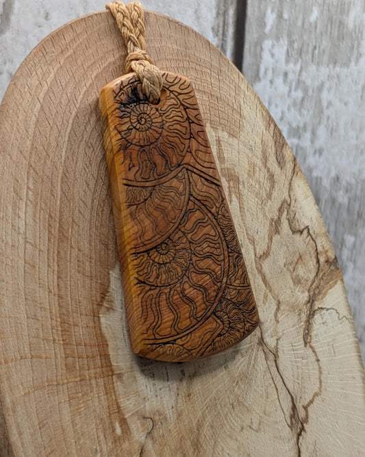 Laser printed all over ammonite on yew wood Pendant.