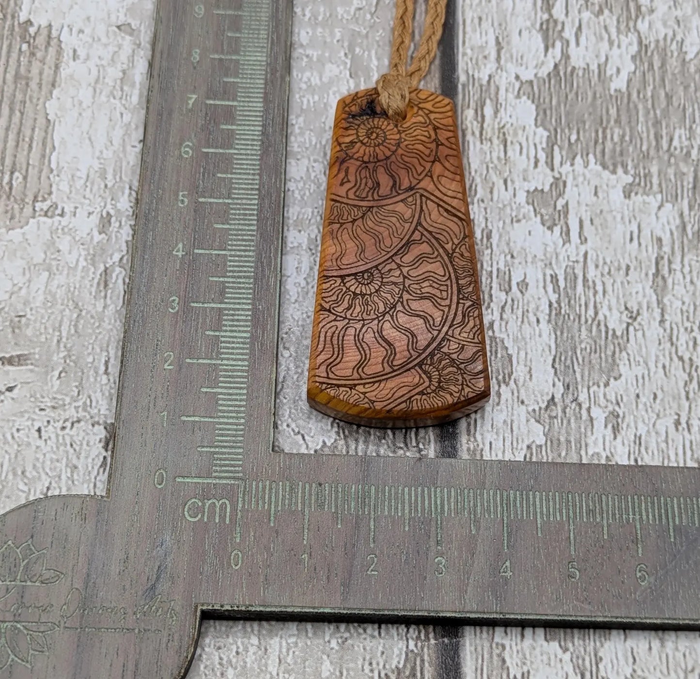 Laser printed all over ammonite on yew wood Pendant.