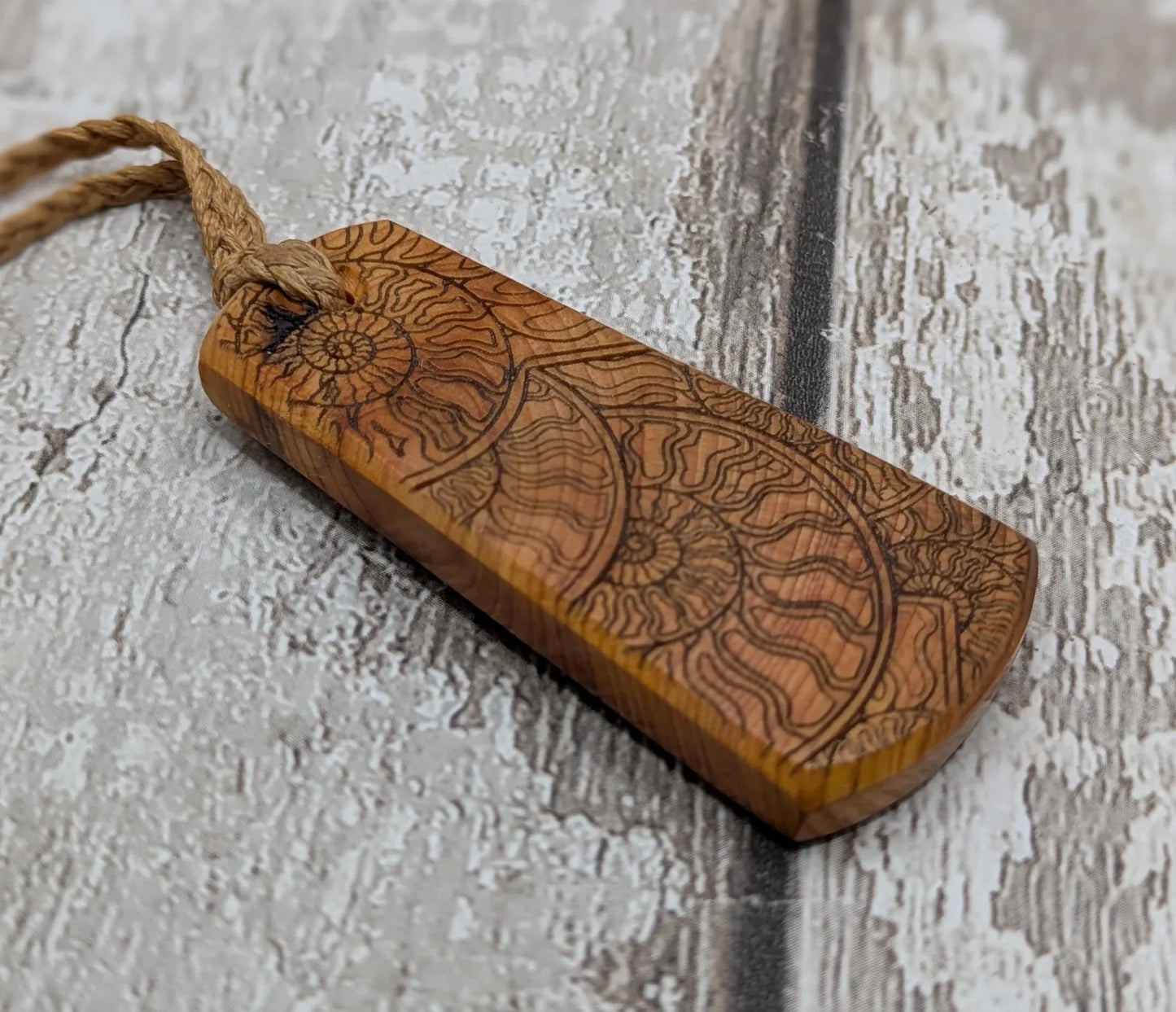 Laser printed all over ammonite on yew wood Pendant.