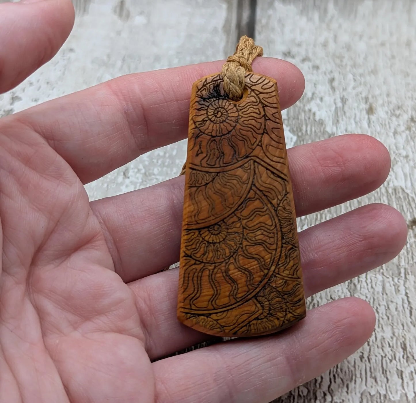 Laser printed all over ammonite on yew wood Pendant.