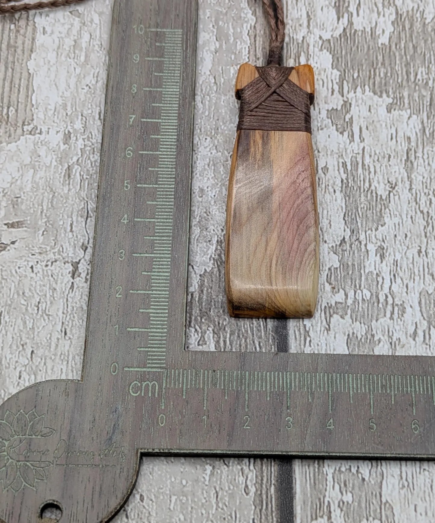 Spalted yew wood Hei Toki adze pendant.