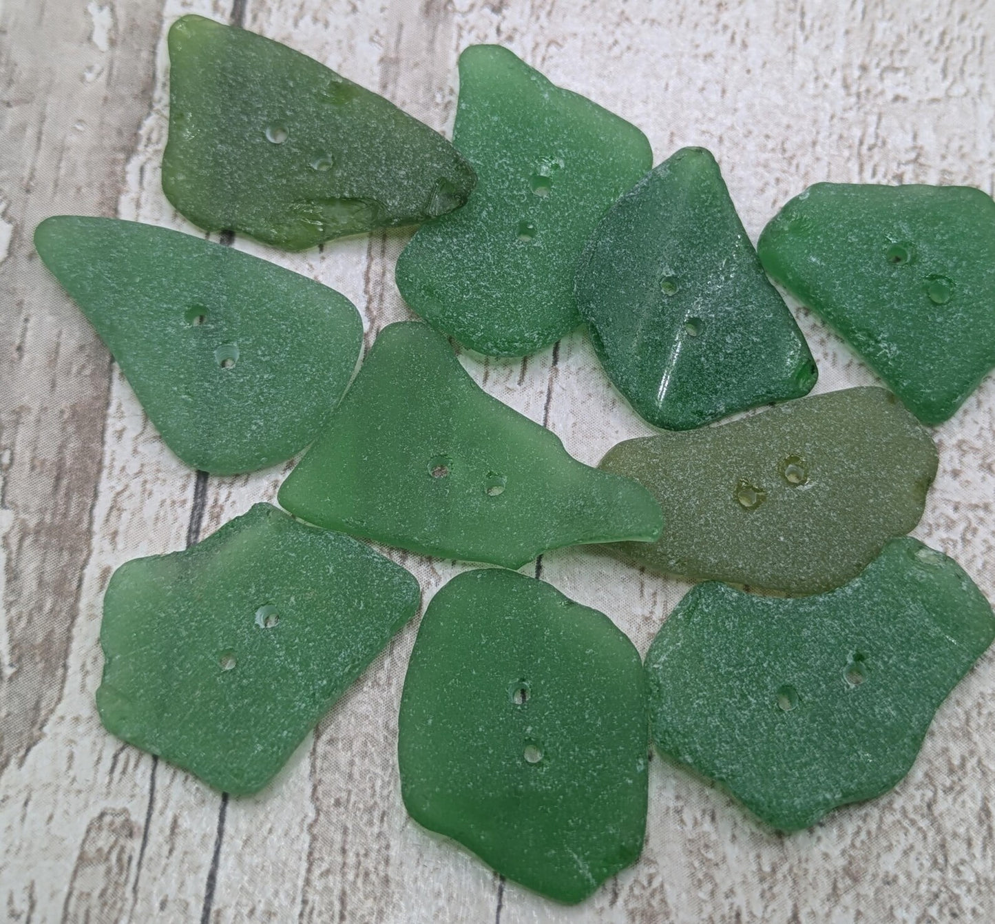 10 green frosted sea glass buttons.
