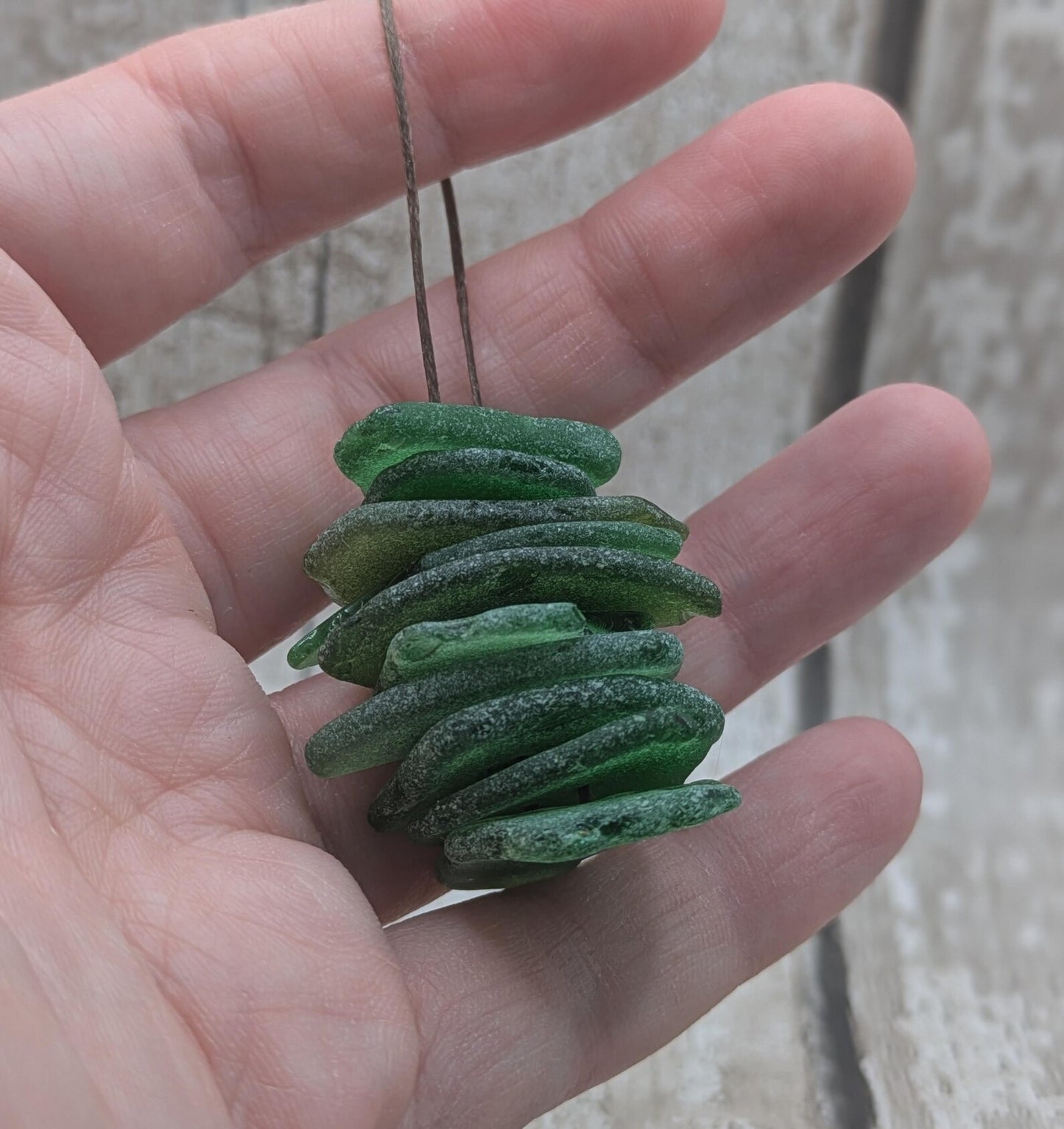 10 green frosted sea glass buttons.