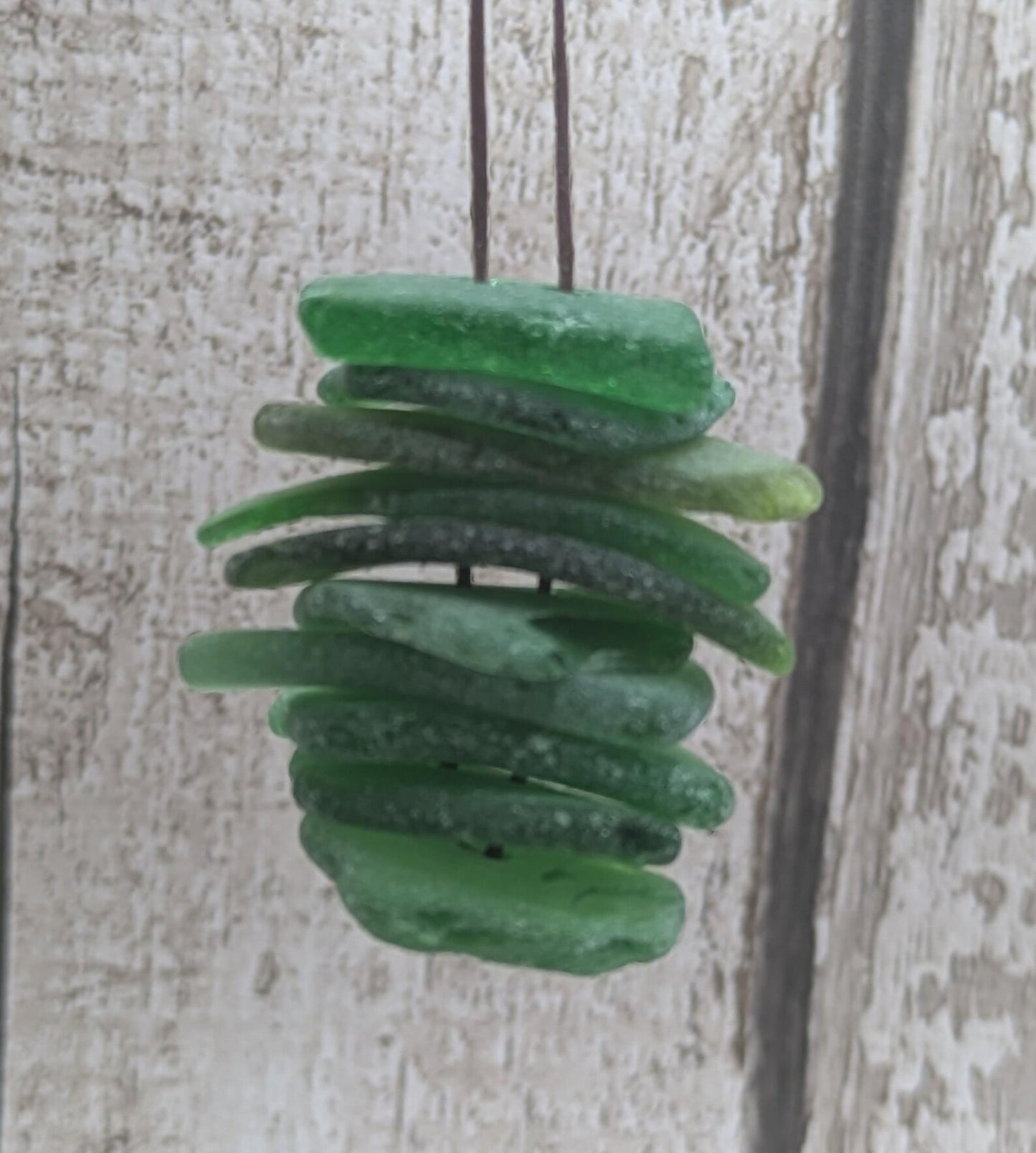10 green frosted sea glass buttons.