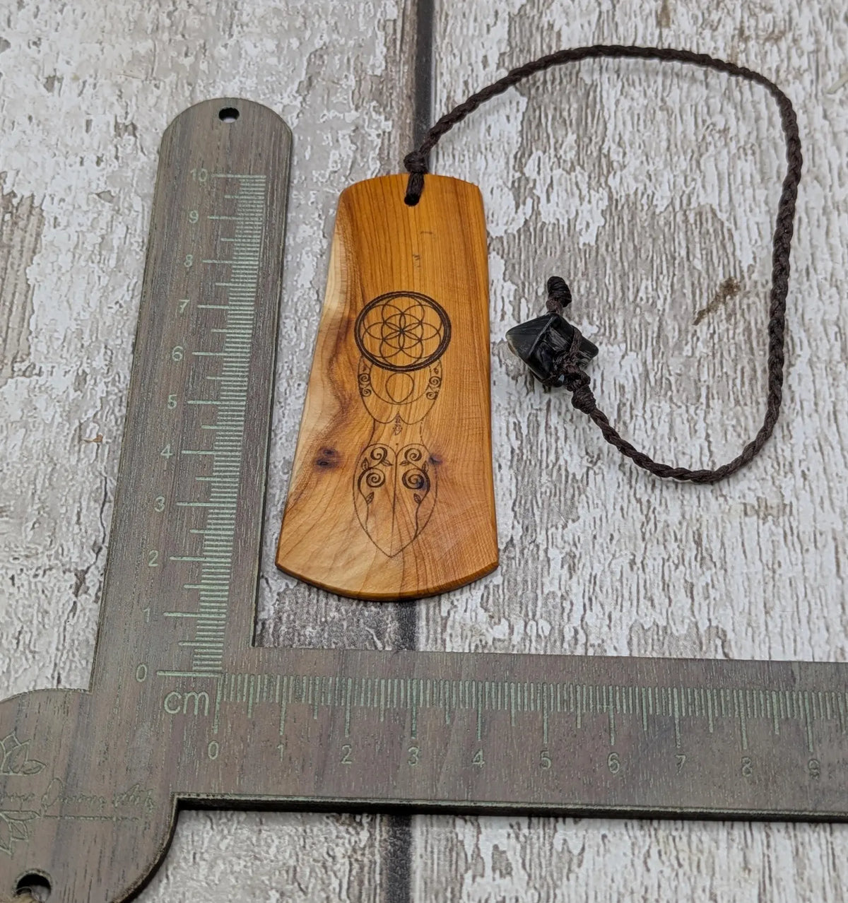 Yew wood, goddess print bookmark with pāua abalone bead tassel.