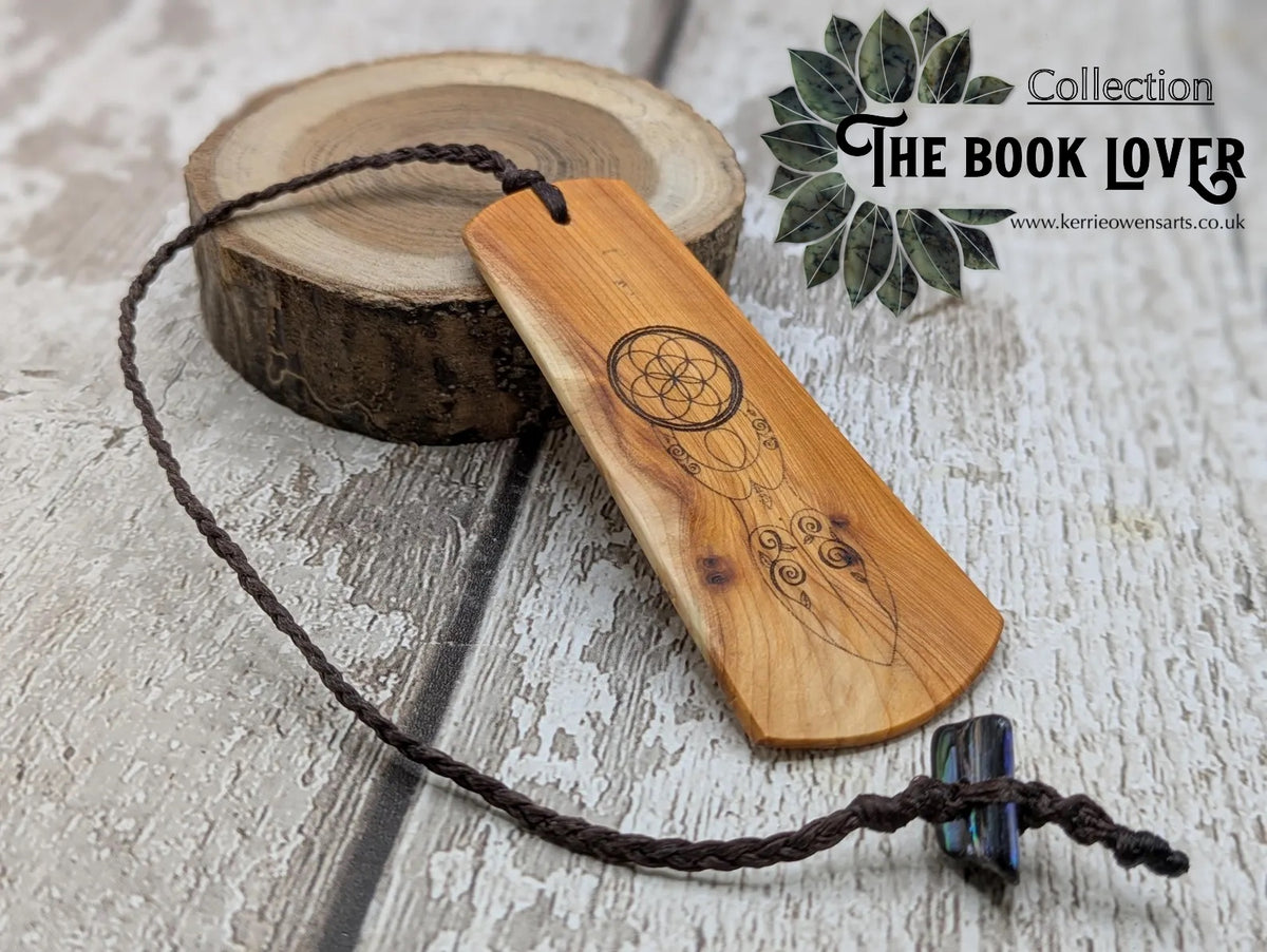 Yew wood, goddess print bookmark with pāua abalone bead tassel.
