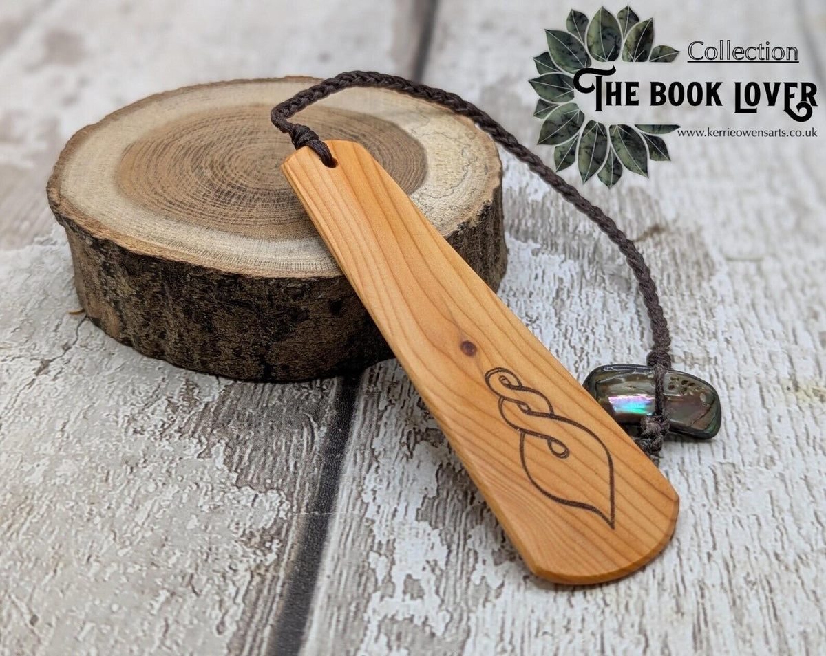 Yew wood pikorua laser printed bookmark with pāua abalone bead tassel.