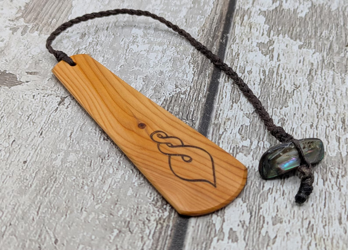 Yew wood pikorua laser printed bookmark with pāua abalone bead tassel.
