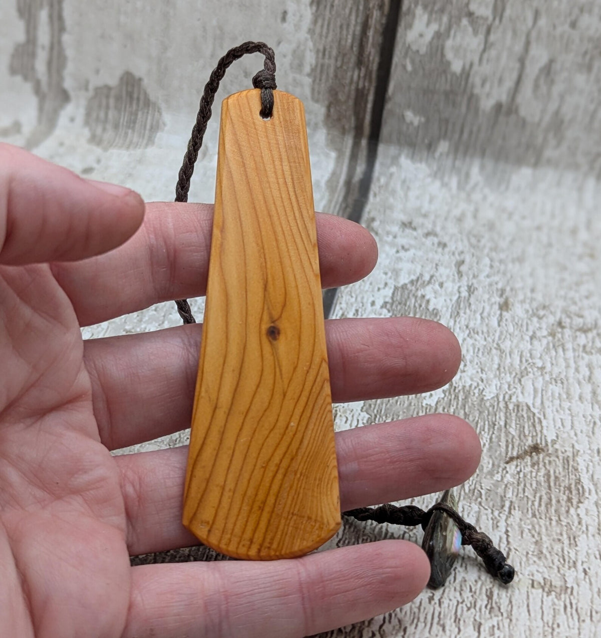 Yew wood pikorua laser printed bookmark with pāua abalone bead tassel.
