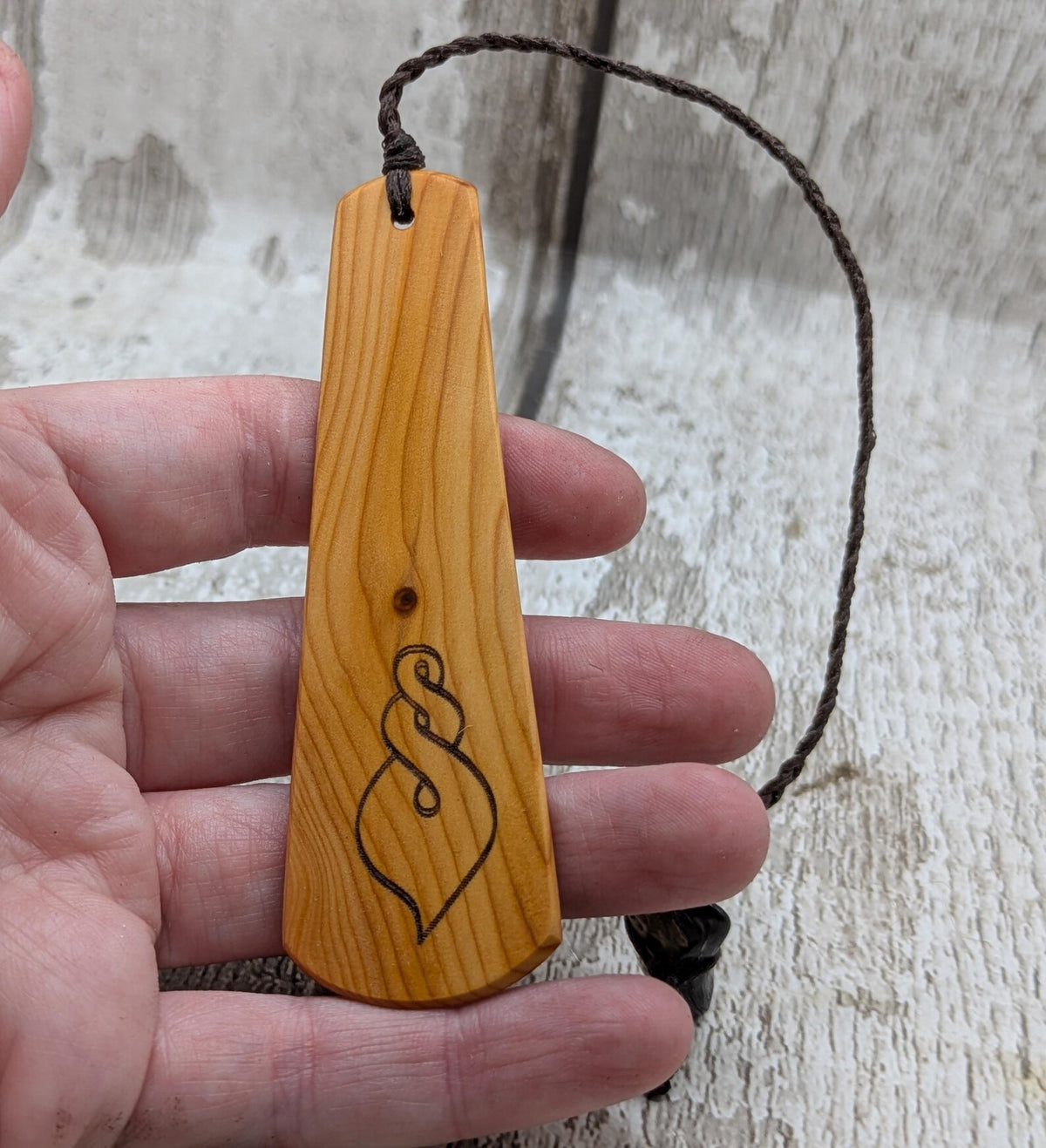 Yew wood pikorua laser printed bookmark with pāua abalone bead tassel.