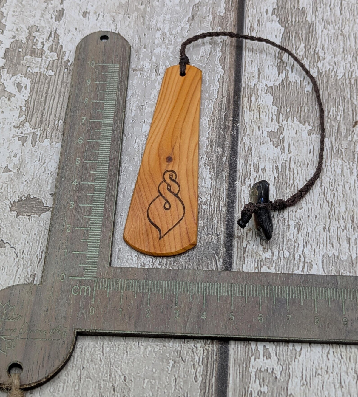 Yew wood pikorua laser printed bookmark with pāua abalone bead tassel.