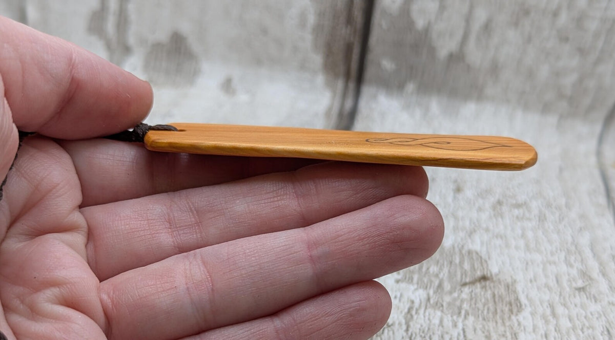 Yew wood pikorua laser printed bookmark with pāua abalone bead tassel.
