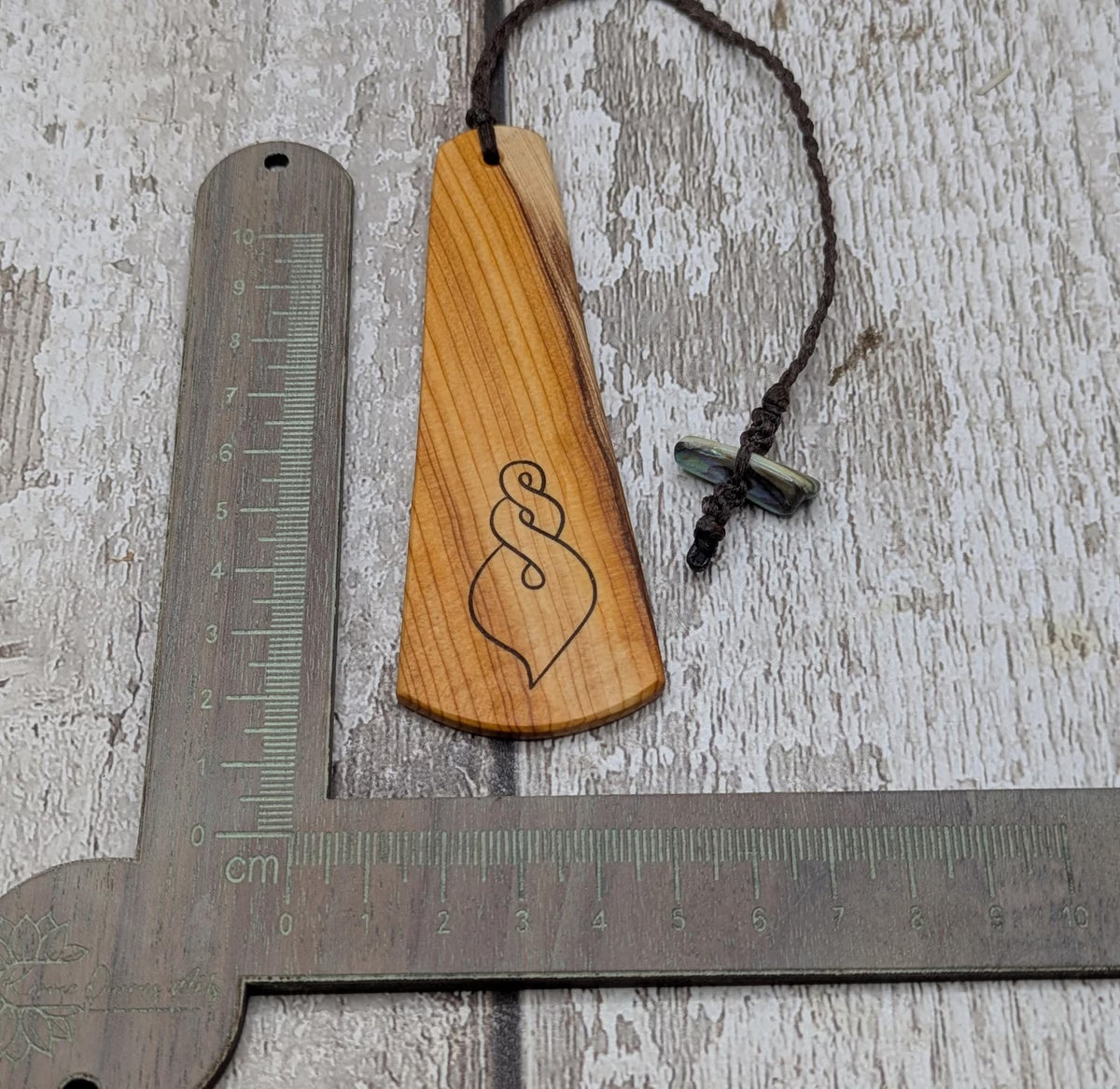 Yew wood pikorua laser printed bookmark with pāua abalone shell bead .