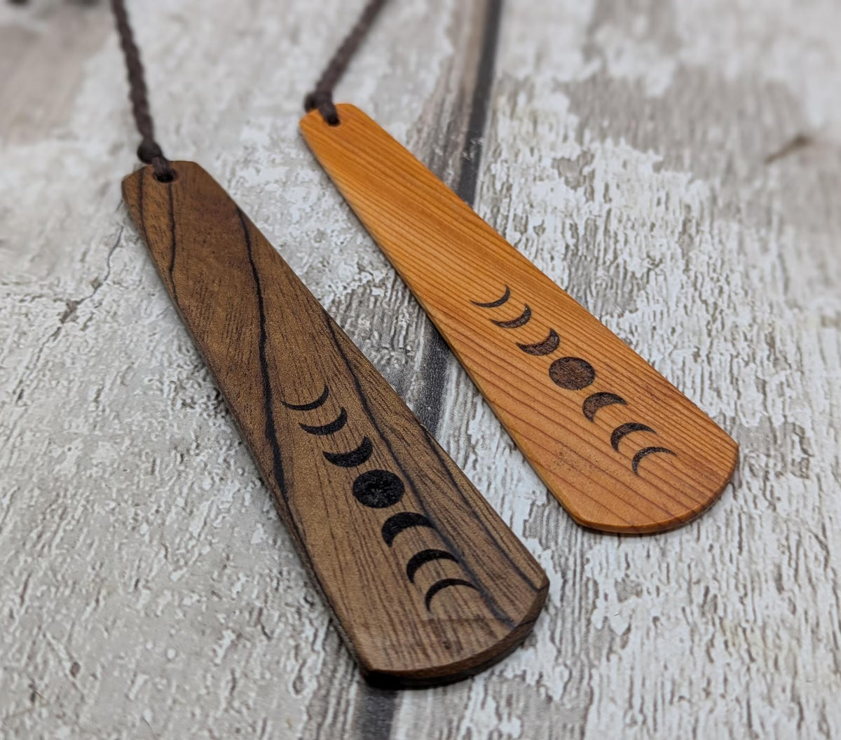 Yew wood with moon phrase laser print and abalone pāua shell bead tassel.