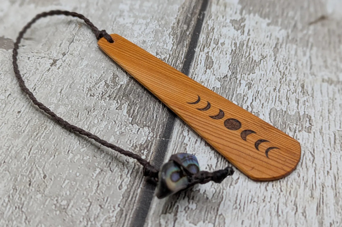 Yew wood with moon phrase laser print and abalone pāua shell bead tassel.