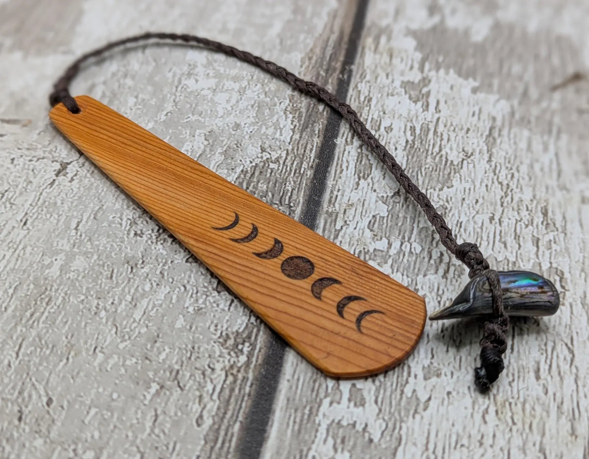 Yew wood with moon phrase laser print and abalone pāua shell bead tassel.