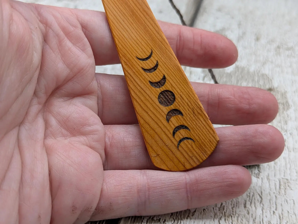 Yew wood with moon phrase laser print and abalone pāua shell bead tassel.