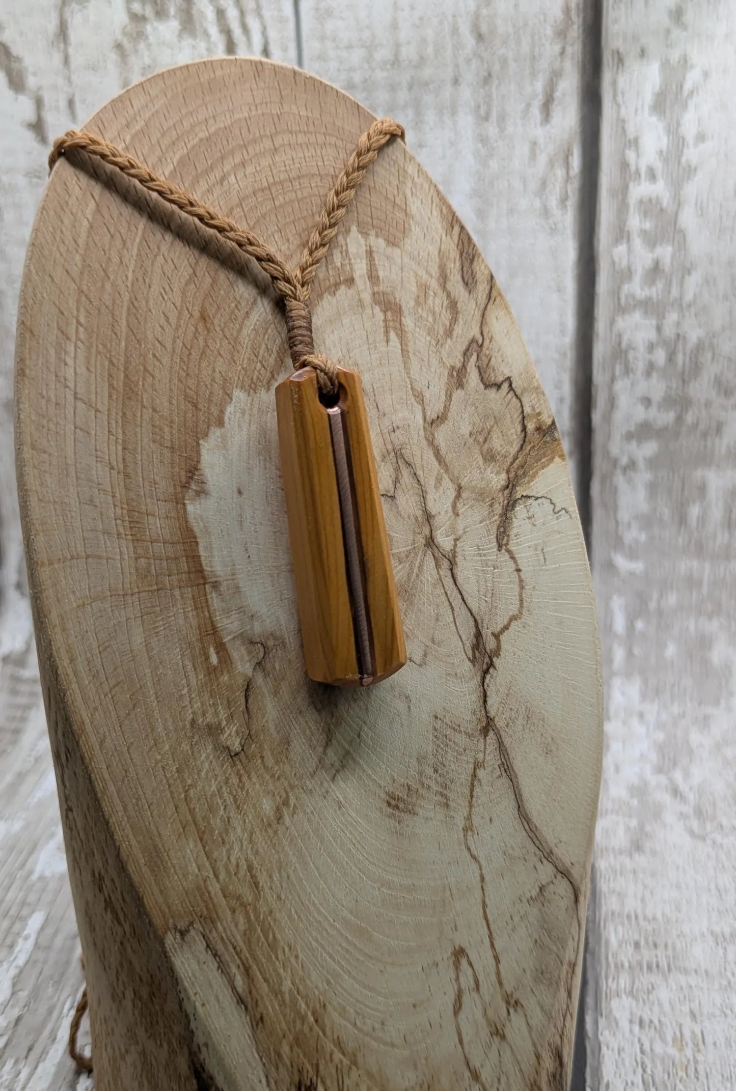 Yew wood roimata drop pendant with copper inlay.