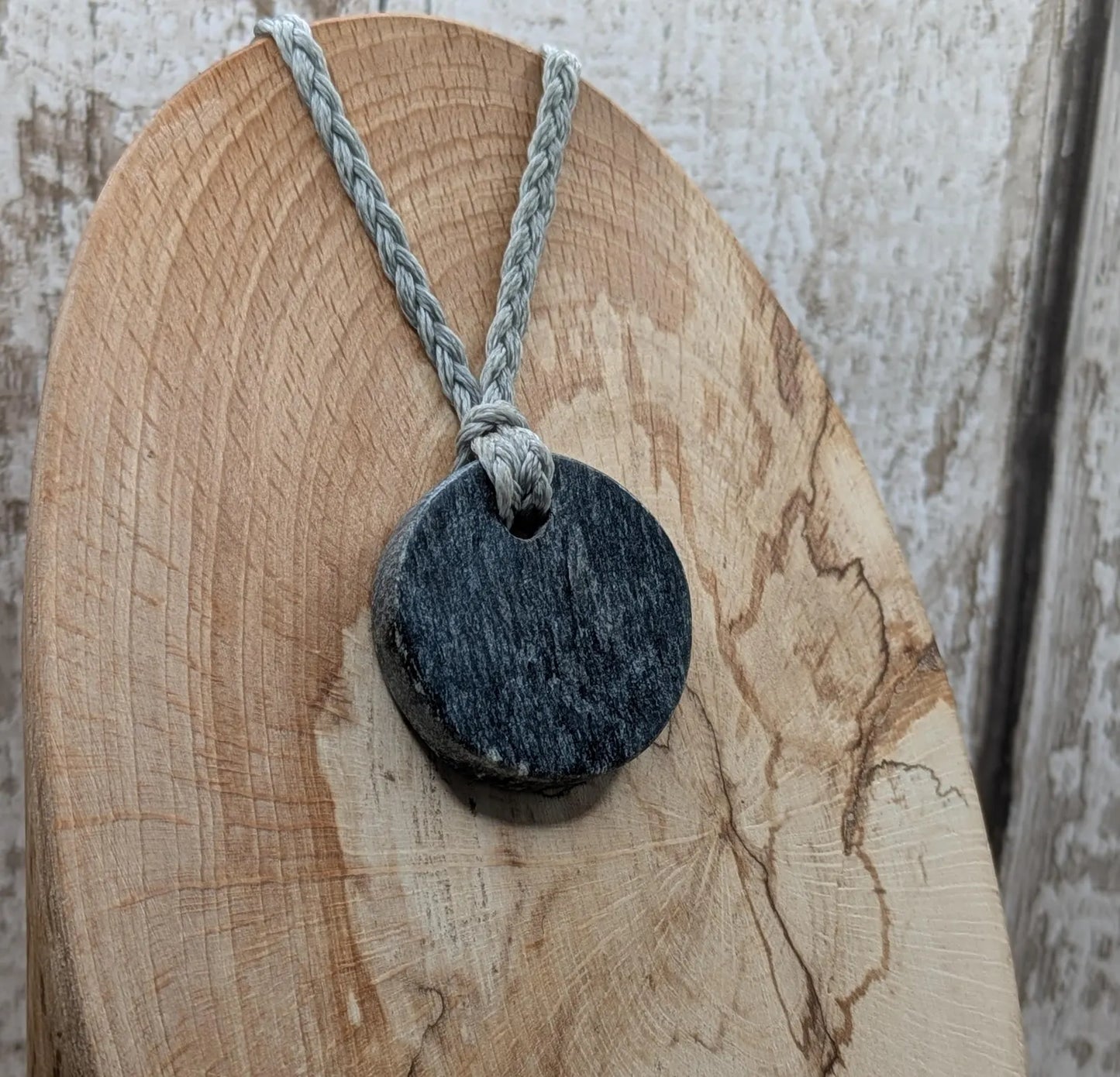 Low grade Shungite asymmetric disc pendants.