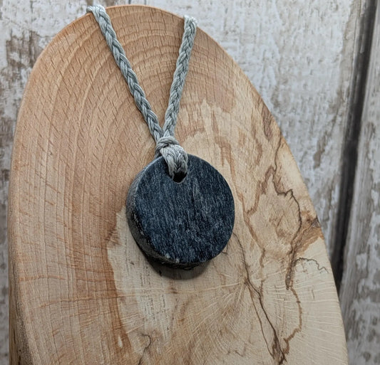 Low grade Shungite asymmetric disc pendants.