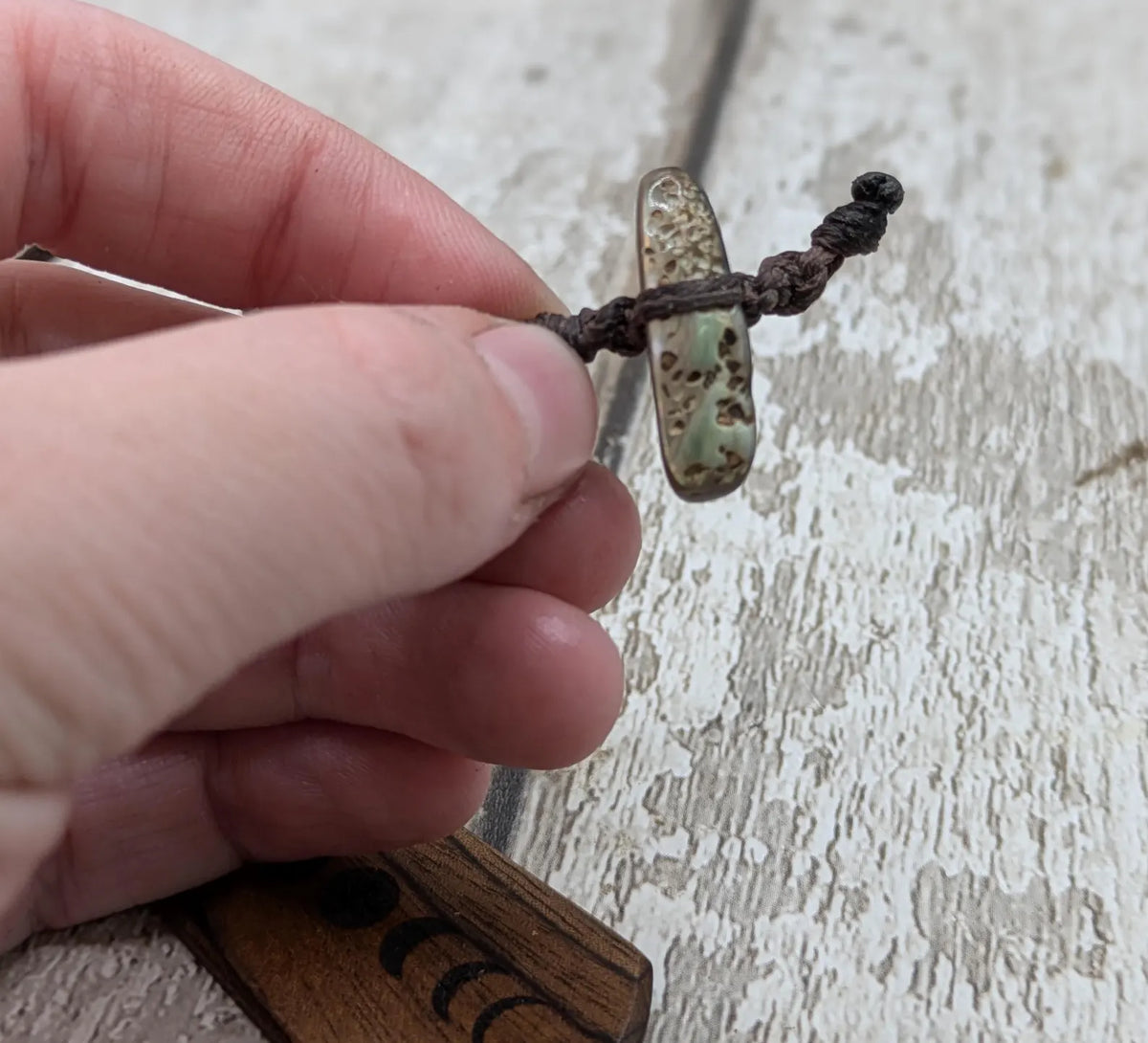 Walnut wood moon phrase laser printed bookmark with pāua abalone shell bead tassel.