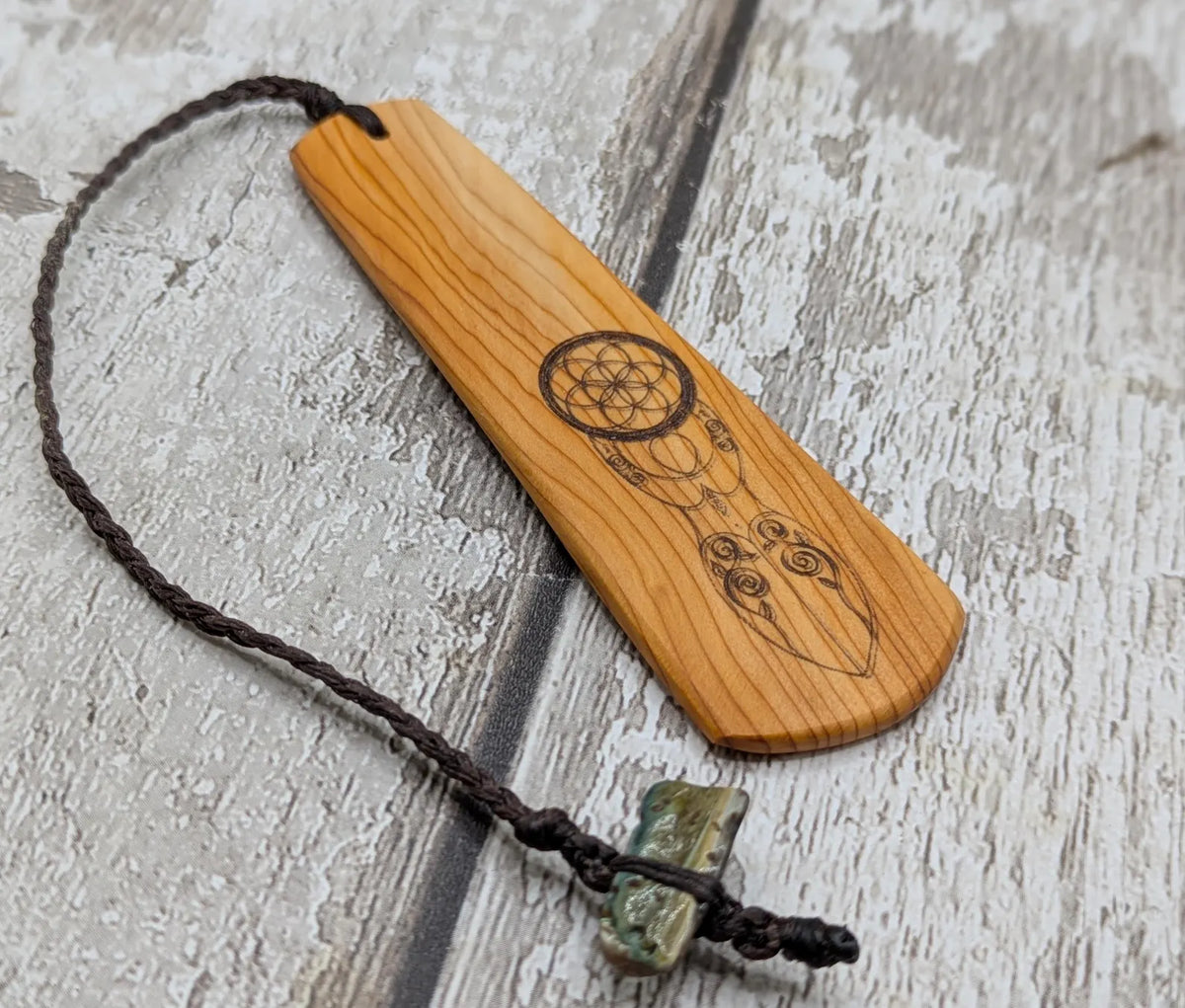 Yew wood, goddess deity laser printed bookmark with pāua shell beaded tassel.