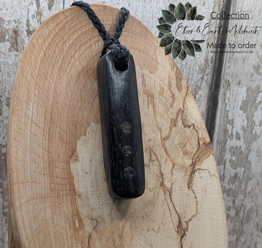 Bog oak wood and moldavite roimata pendant.