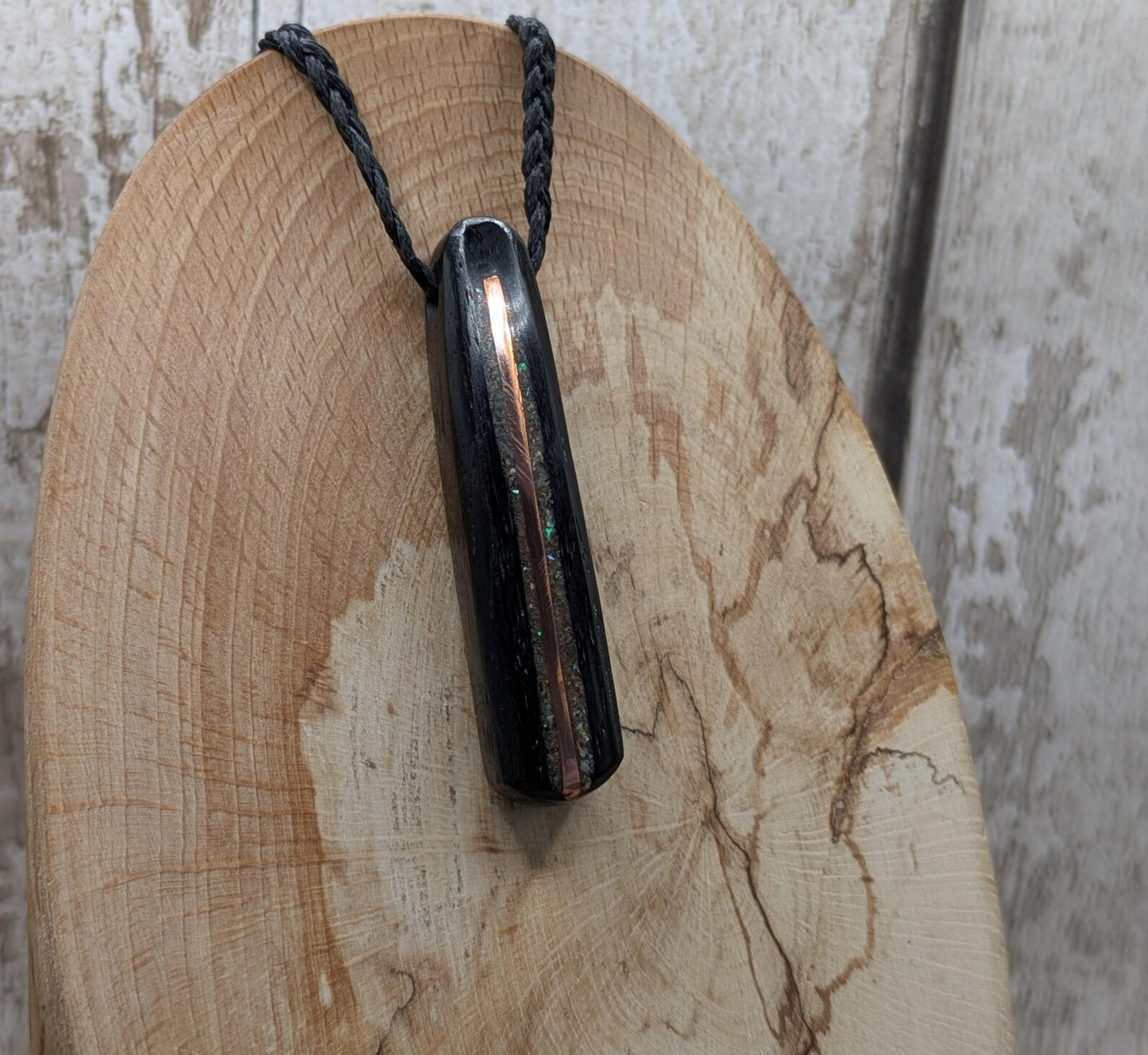 Fenland bog oak roimata pendant with copper wire and abalone shell.