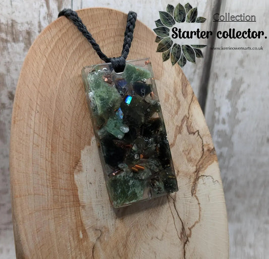Mixed nephrite jade and copper in resin pendant.