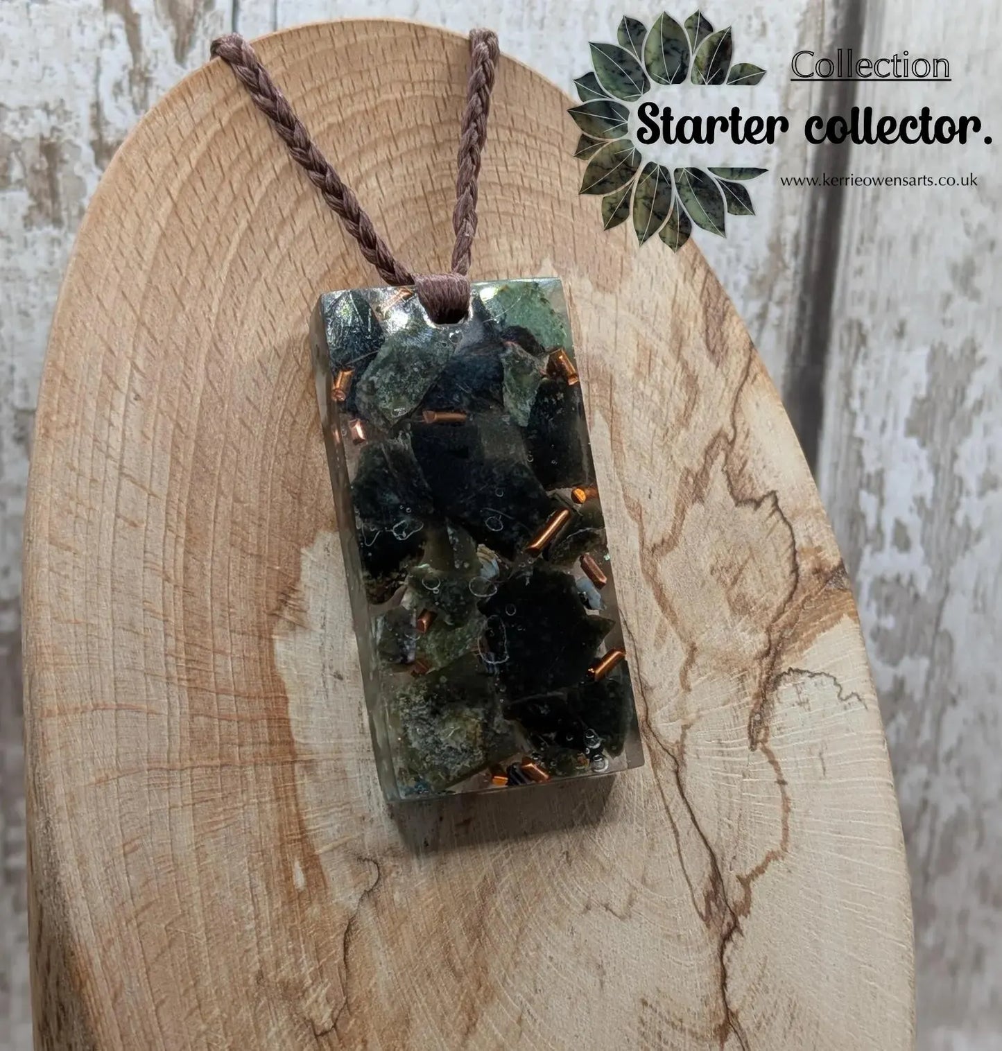Mixed nephrite jade and copper in resin pendant.