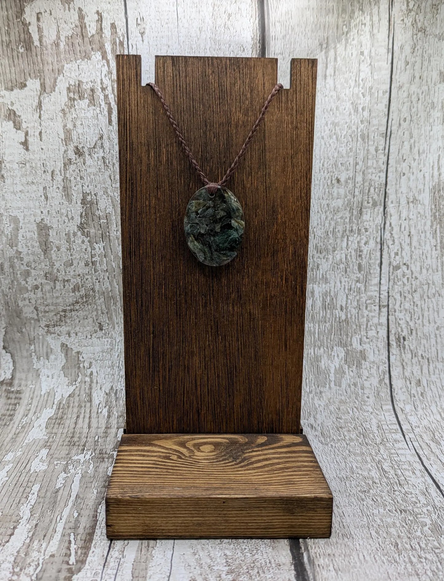 Oval mixed Pounamu jade offcuts in epoxy resin pendant.