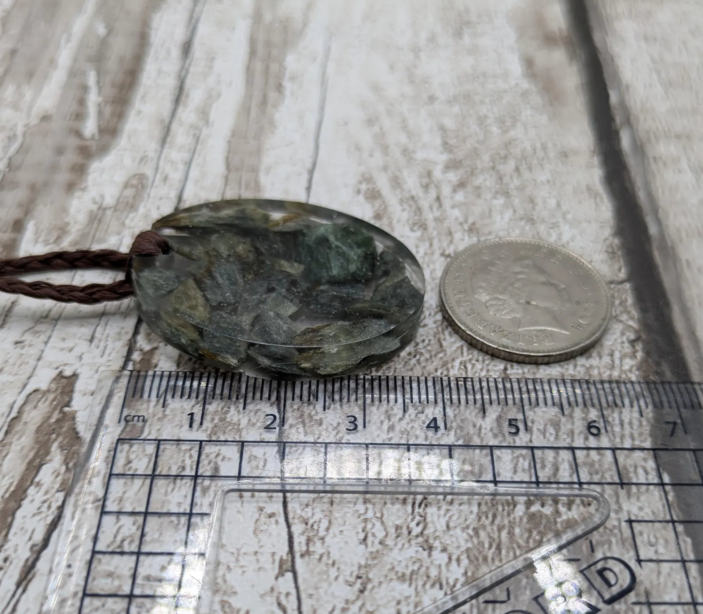 Oval mixed Pounamu jade offcuts in epoxy resin pendant.