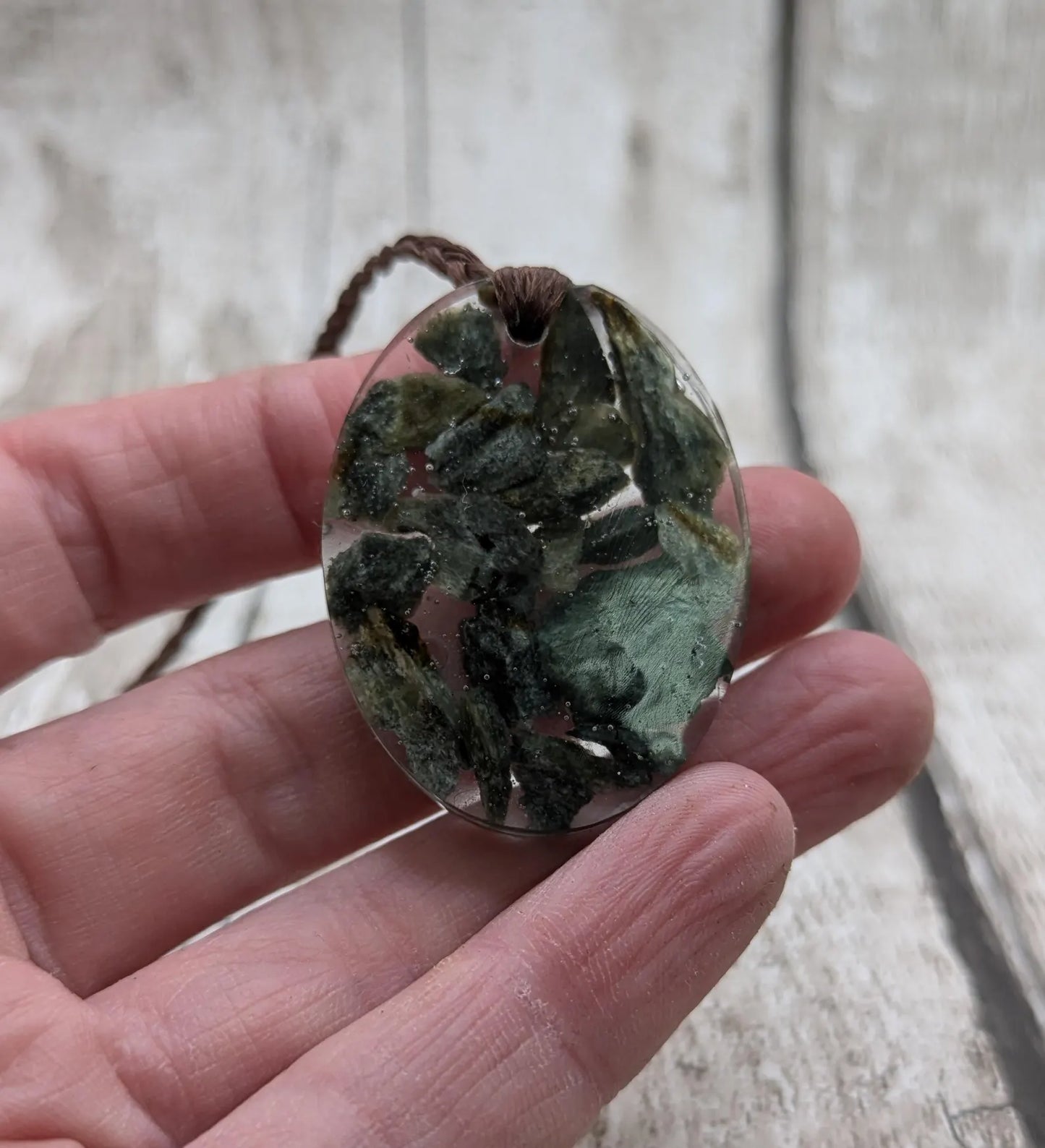 Oval mixed Pounamu jade offcuts in epoxy resin pendant.