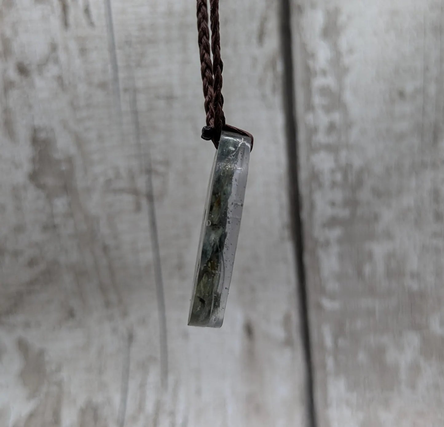 Oval mixed Pounamu jade offcuts in epoxy resin pendant.