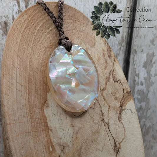 Oval mussel shell resin cast pendant.