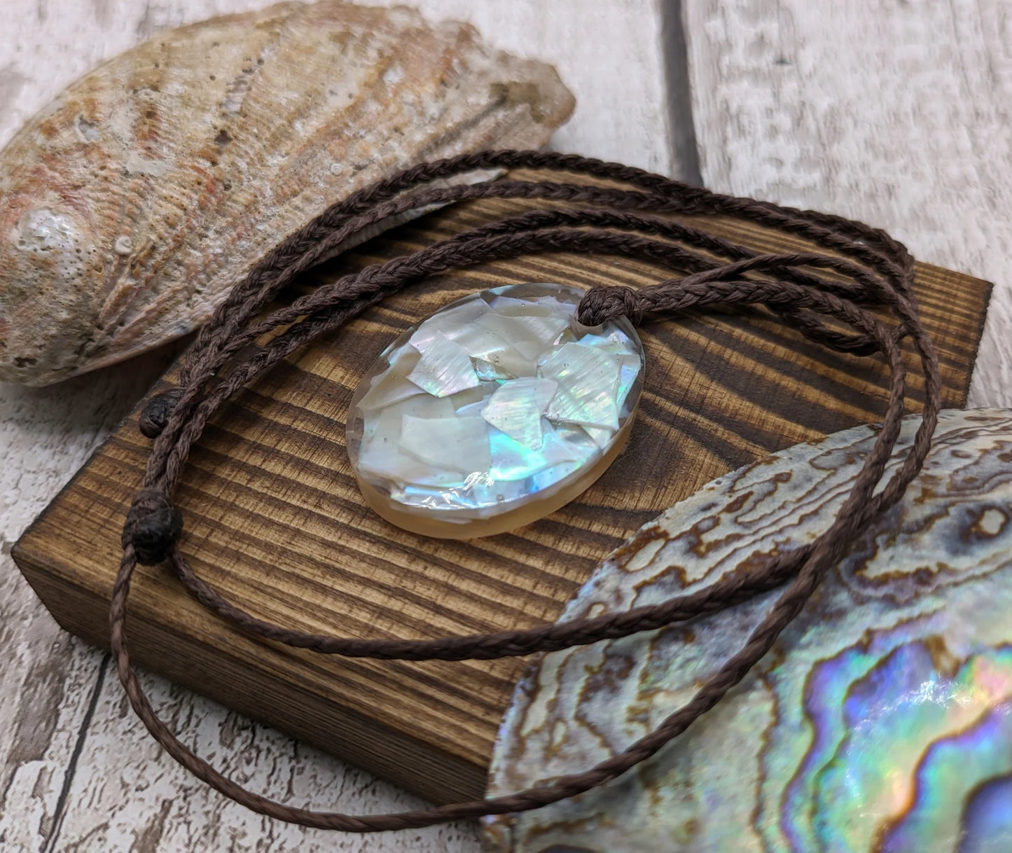 Oval mussel shell resin cast pendant.