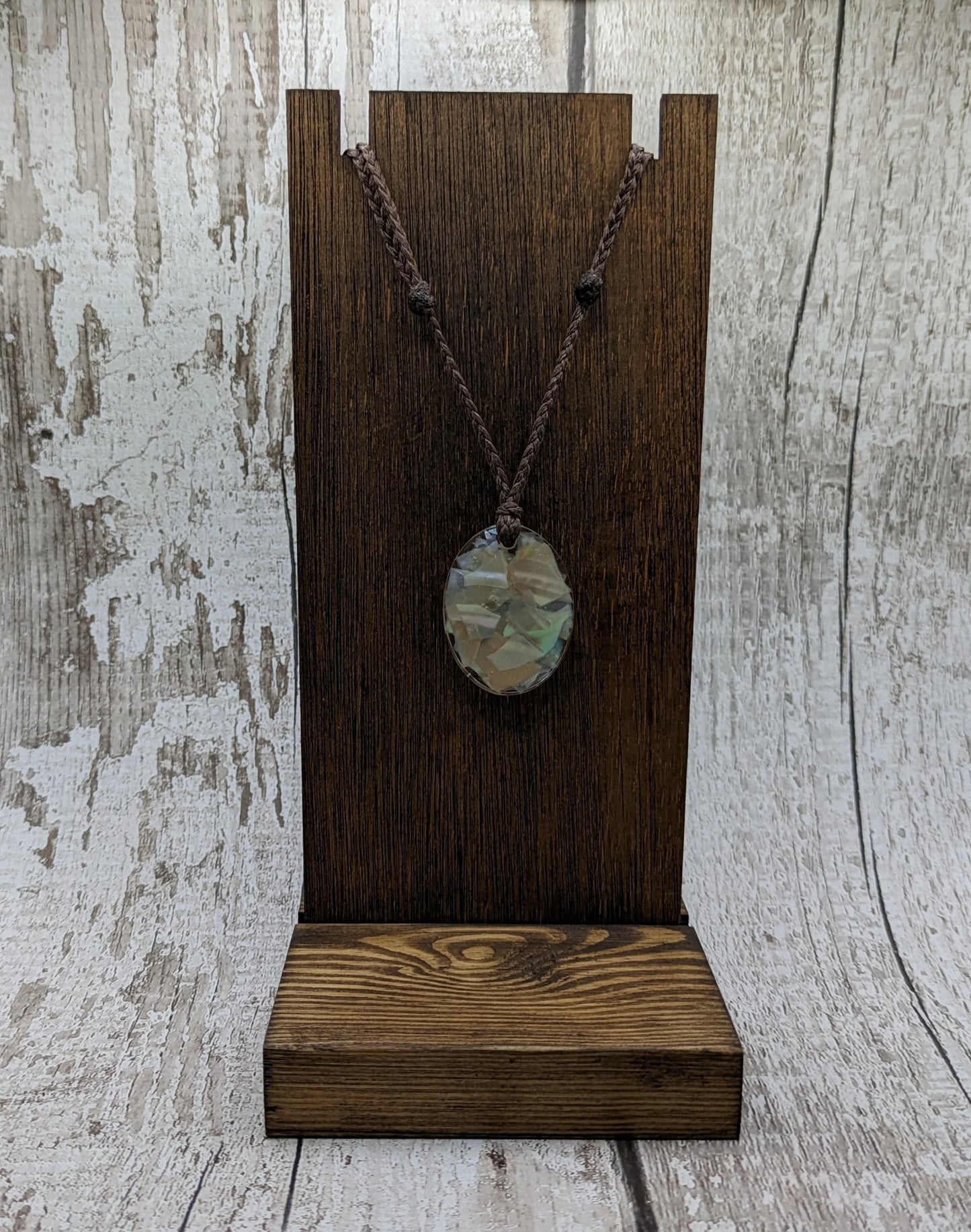 Oval mussel shell resin cast pendant.