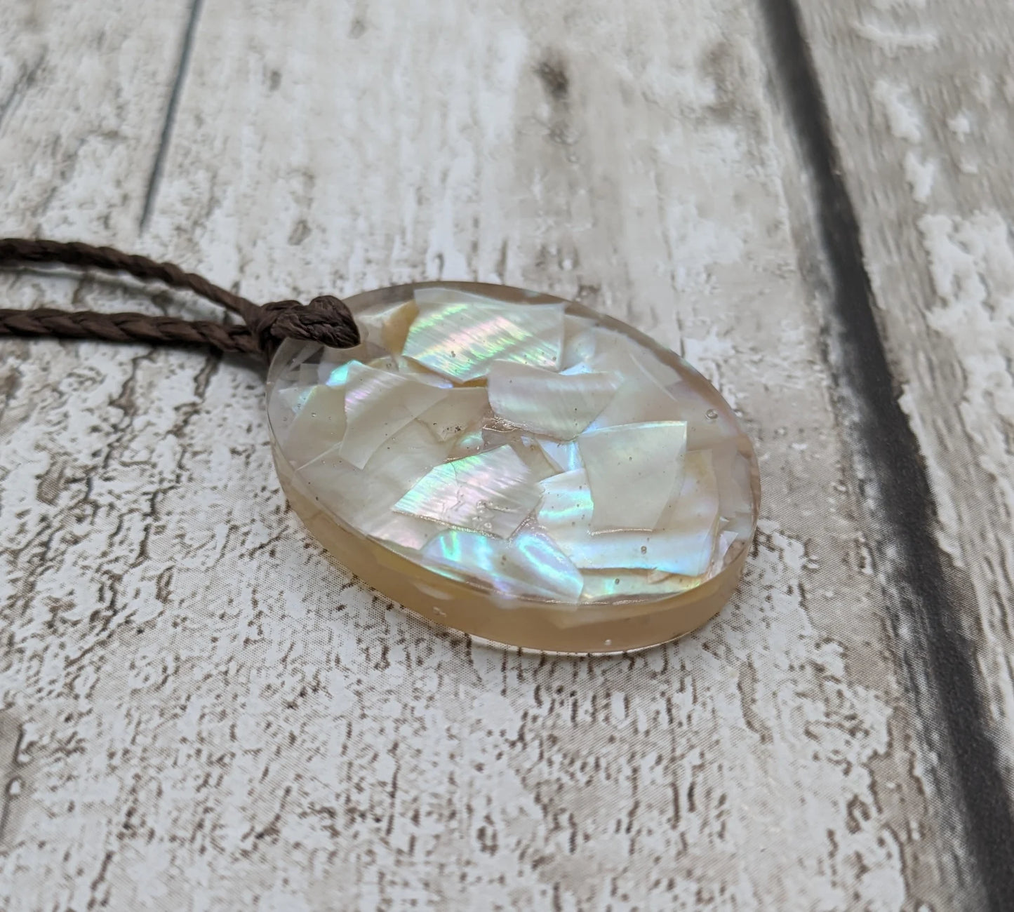 Oval mussel shell resin cast pendant.