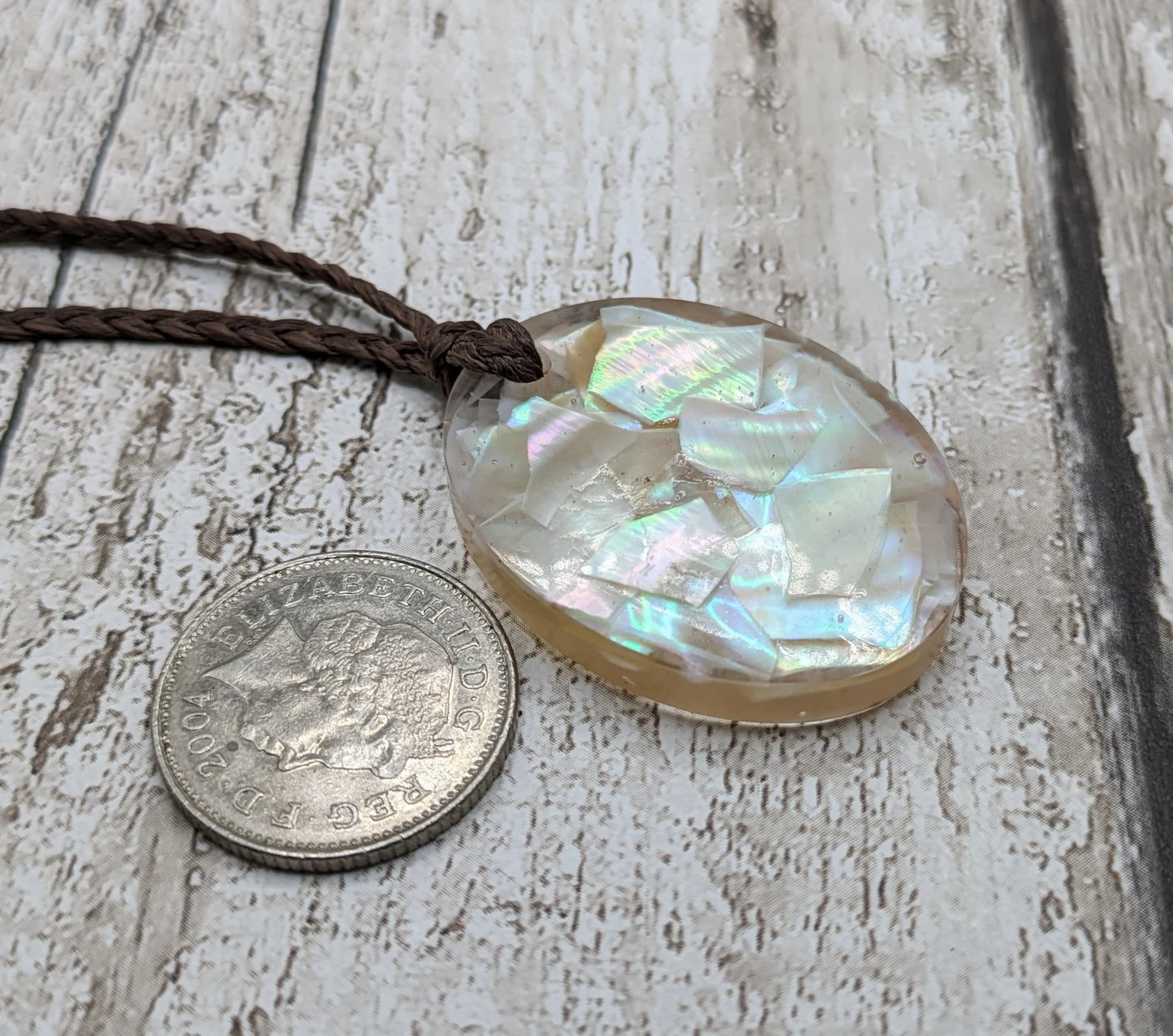 Oval mussel shell resin cast pendant.