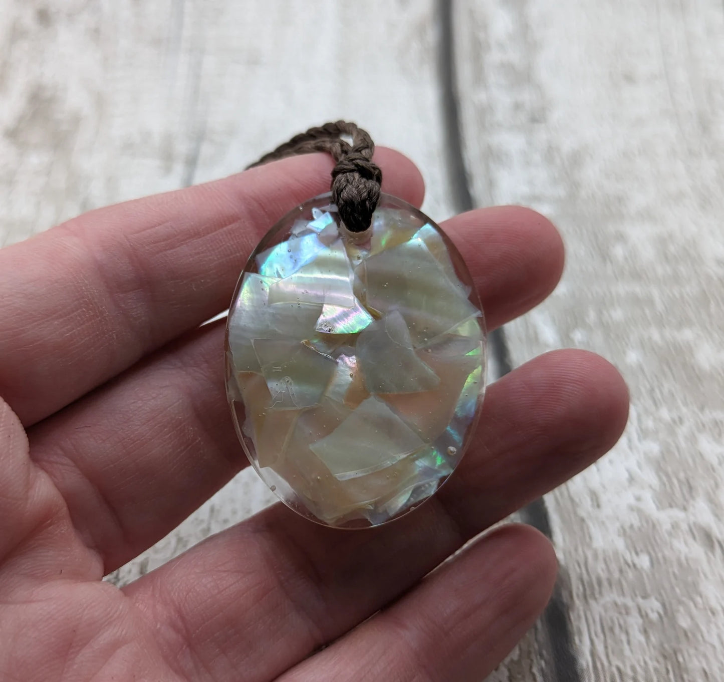 Oval mussel shell resin cast pendant.