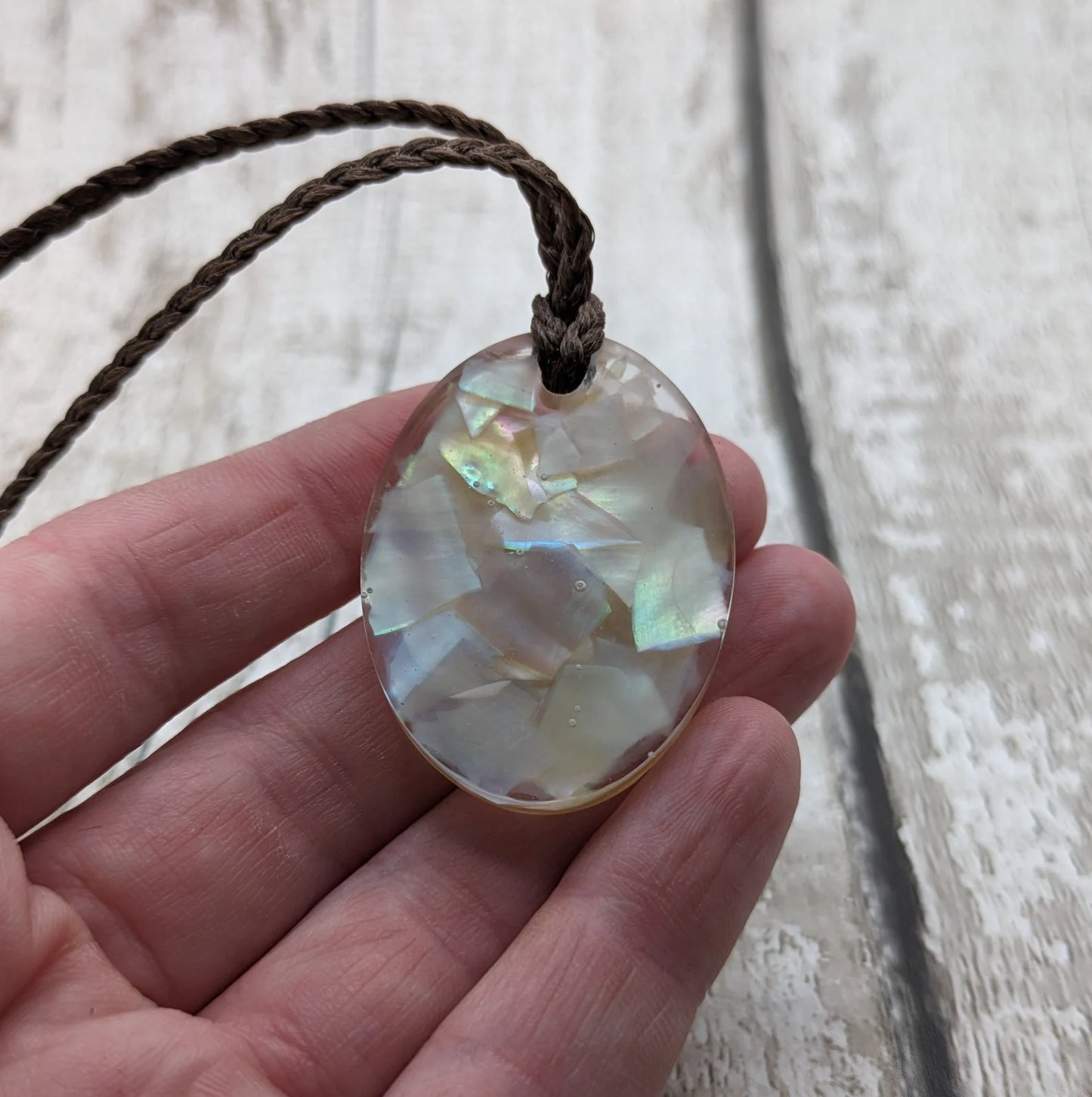 Oval mussel shell resin cast pendant.