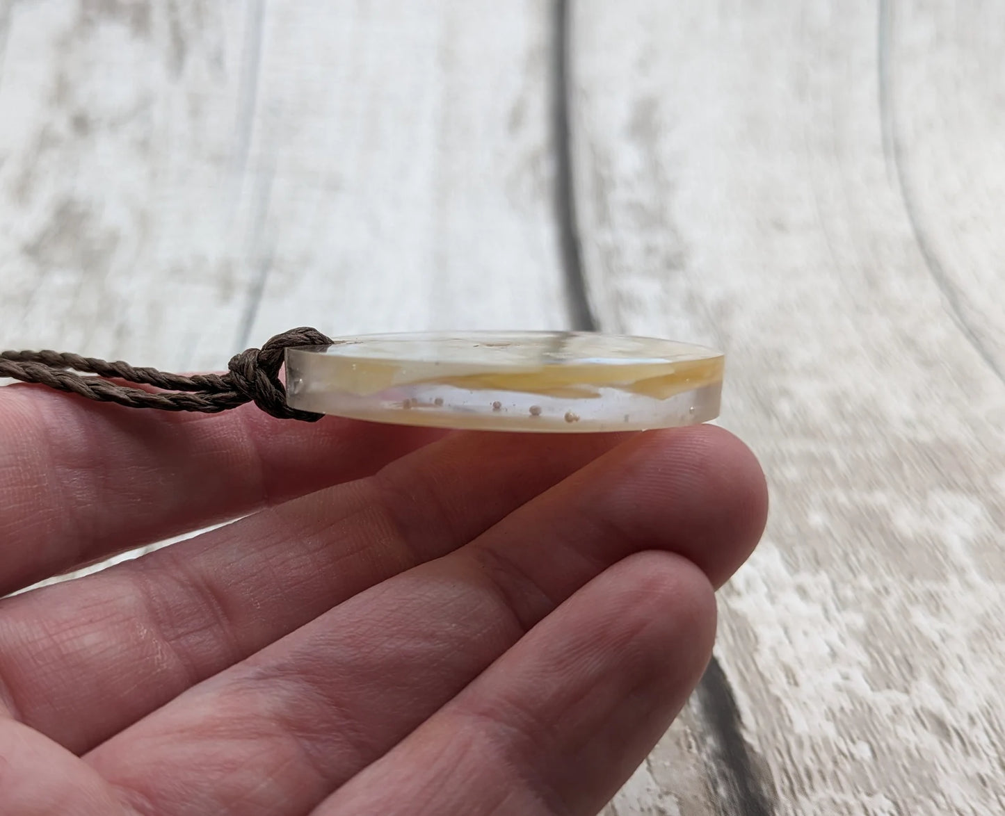 Oval mussel shell resin cast pendant.
