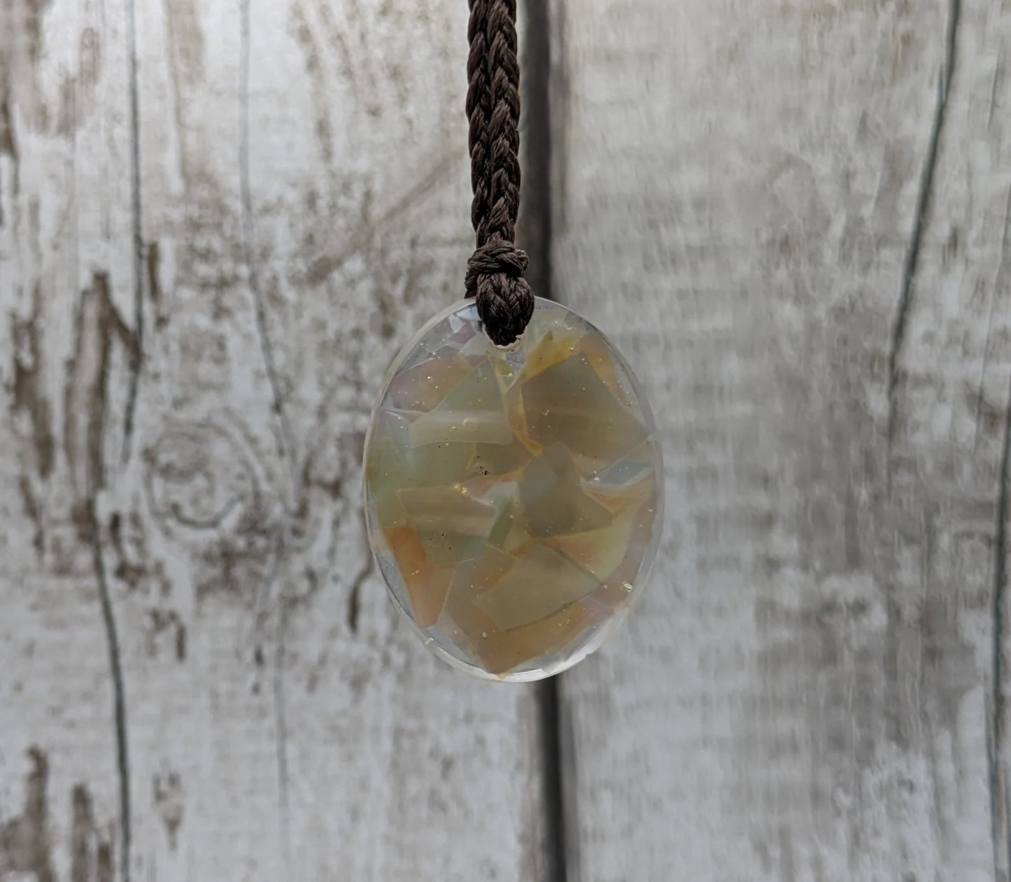 Oval mussel shell resin cast pendant.