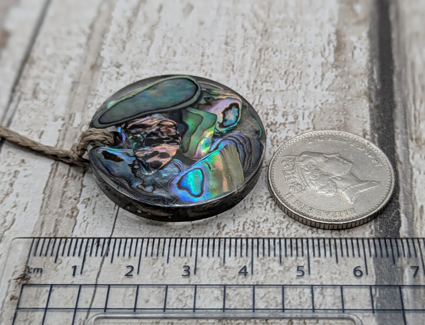 Wild New Zealand rainbow Pāua shell in epoxy resin pendant.