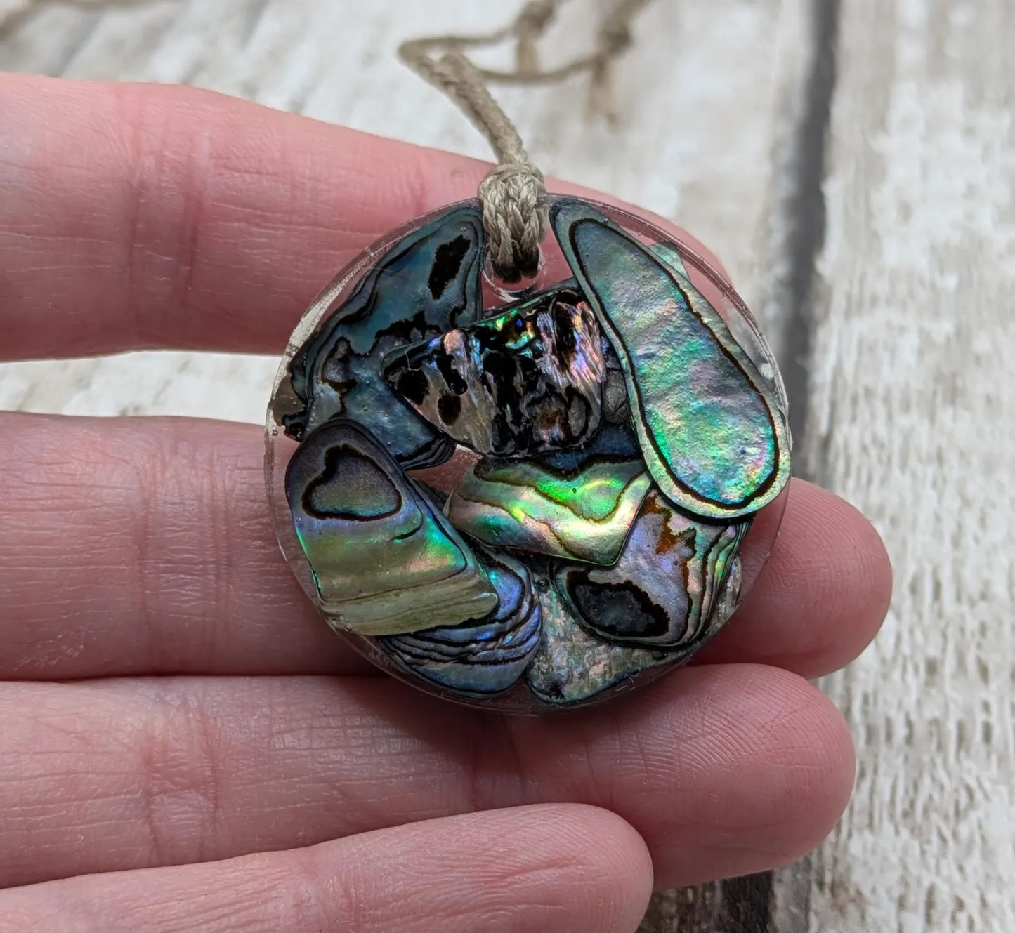 Wild New Zealand rainbow Pāua shell in epoxy resin pendant.