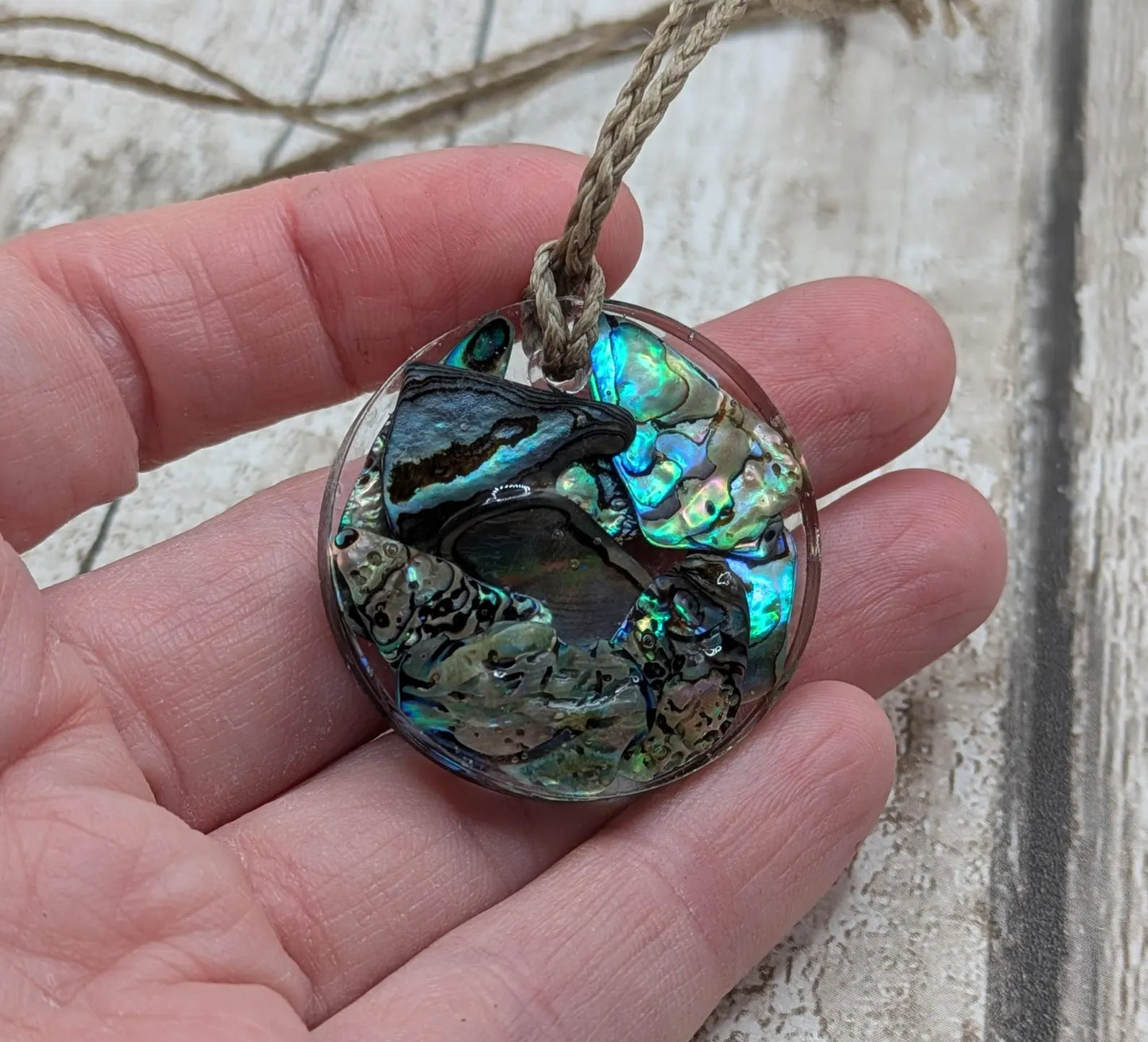 Wild New Zealand rainbow Pāua shell in epoxy resin pendant.