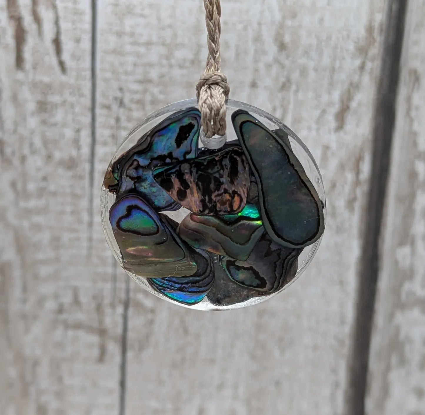 Wild New Zealand rainbow Pāua shell in epoxy resin pendant.
