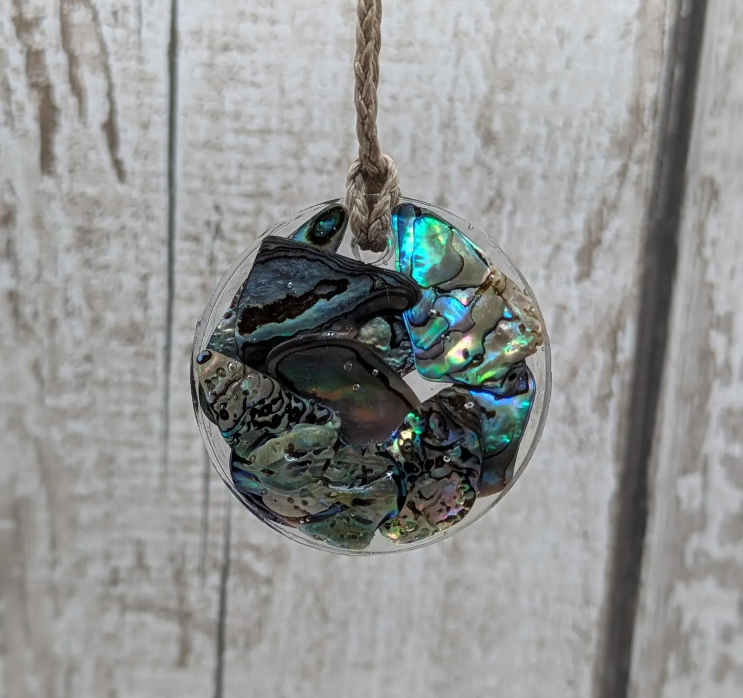 Wild New Zealand rainbow Pāua shell in epoxy resin pendant.