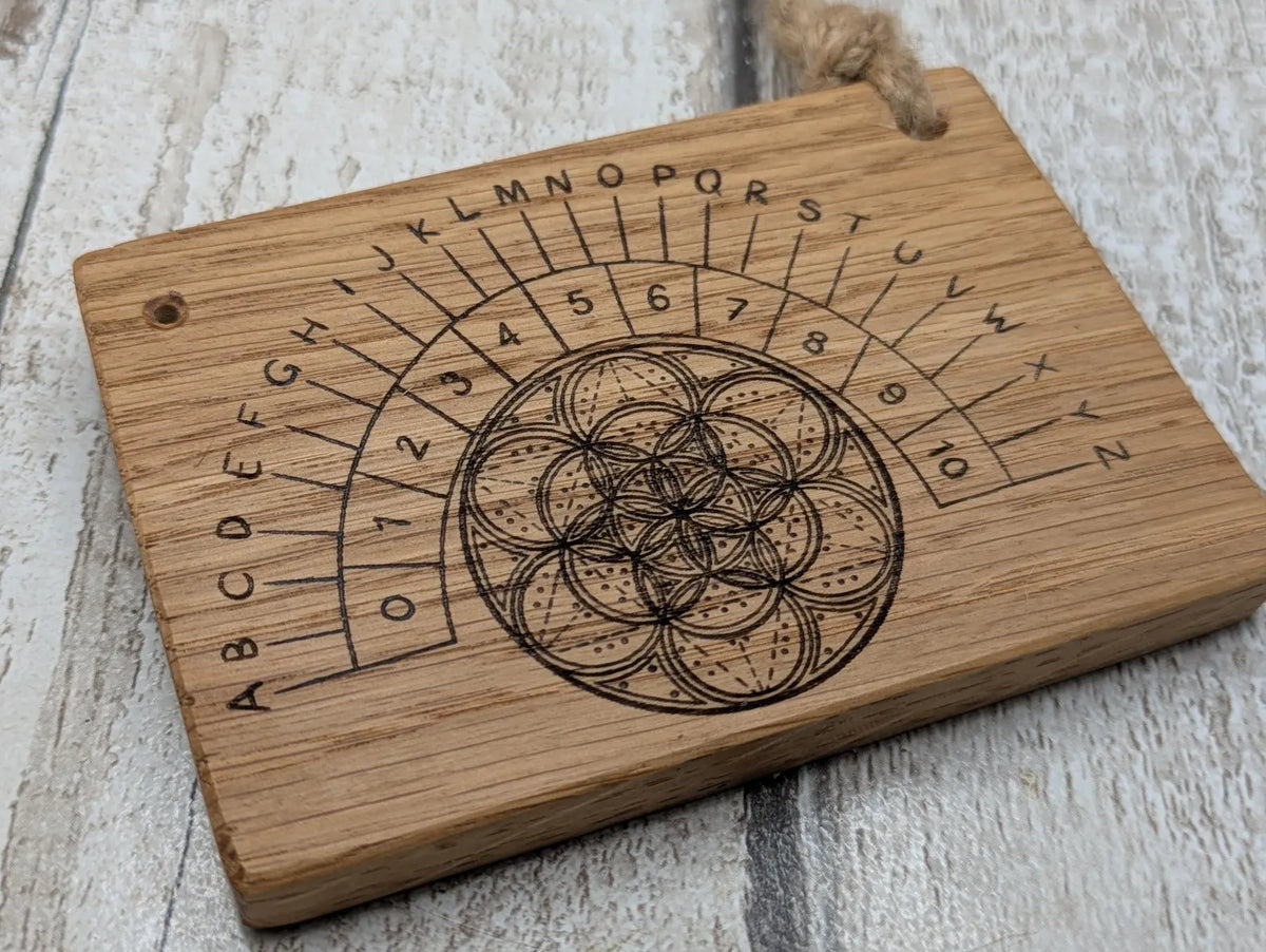 Oak wood pocket pendulum with geometric laser print. Travel sized.